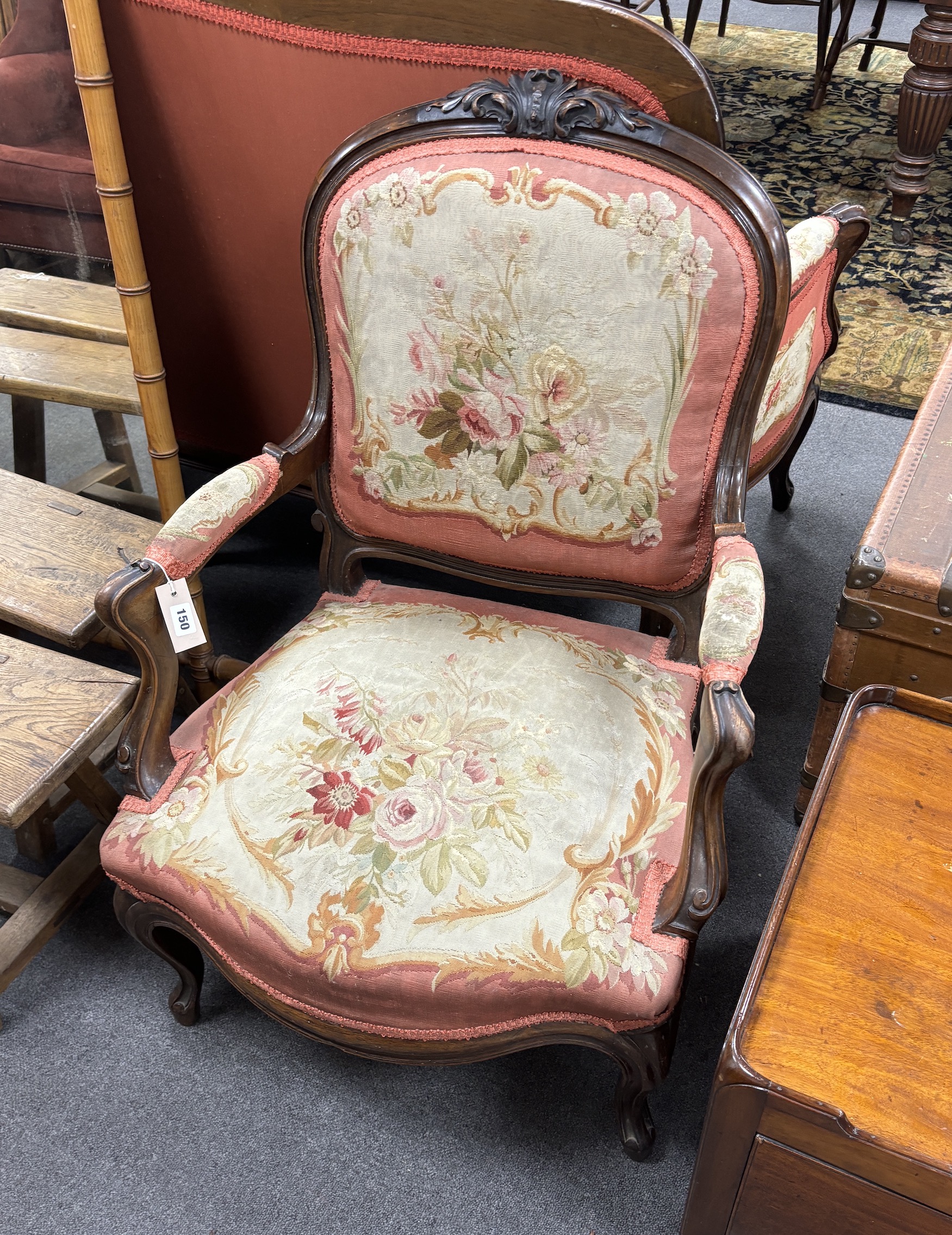A pair of 19th century French rosewood open armchairs with floral needlepoint upholstery, width 66cm, depth 54cm, height 94cm